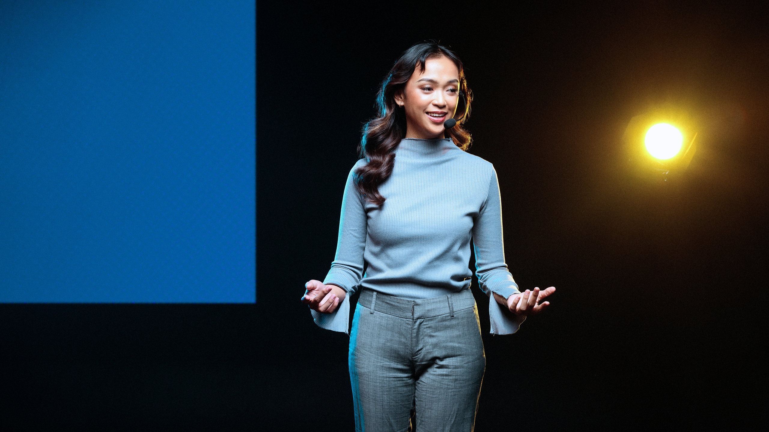 What You’ll Experience card 1 Woman speaking on stage